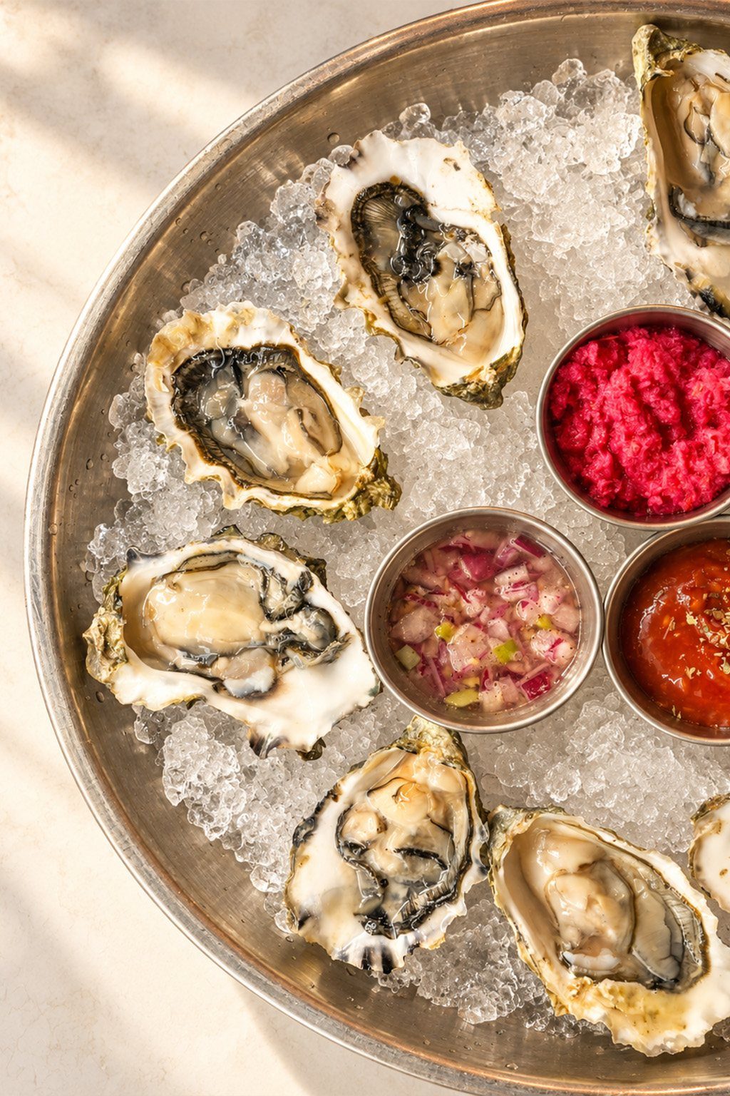 Oysters on crushed ice with beet horseradish, mignonette and cocktail sauce